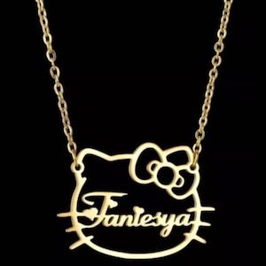 May include: Gold-tone necklace with a Hello Kitty-shaped pendant featuring the name "Fantessya" inside.