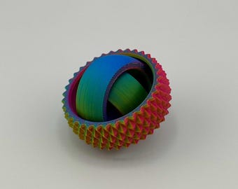 May include: A colorful, 3D-printed sphere with a textured, spiky outer ring in shades of red, yellow, and green. The inner ring is a smooth gradient of blue and green. The sphere is a unique, eye-catching decorative item.