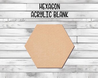 May include: A hexagon-shaped blank acrylic craft piece. The piece is light brown and has a smooth surface. It is perfect for painting, decoupage, or other craft projects.