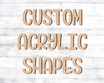 May include: Custom acrylic shapes in a light brown color against a white wood background. The words "CUSTOM ACRYLIC SHAPES" are written in a bold, cursive font.