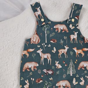 Green, Forest Animal fabric Dungarees. Fully double lined with popper shoulders.
