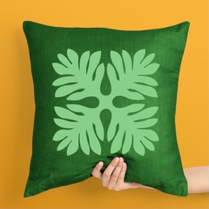 May include: Green throw pillow with a light green leaf pattern. The pillow is made of a soft, textured fabric.