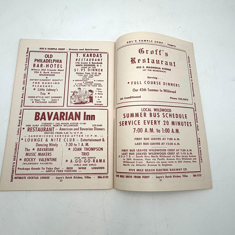 May include: Open vintage brochure featuring advertisements for restaurants and entertainment venues in Wildwood, New Jersey. Includes listings for the Old Philadelphia Bar-Hotel, T. Kardas Restaurant, and Bavarian Inn, with details on dining, entertainment, and bus schedules.