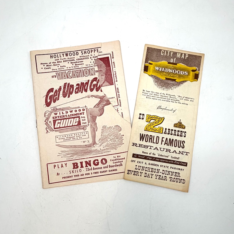 May include: Two vintage Wildwood, New Jersey, ephemera pieces. One is a brochure with the text "It's Vacation Get Up and Go" and a surfer graphic. The other is a map of Wildwoods and an advertisement for Ed Zaberer's World Famous Restaurant.
