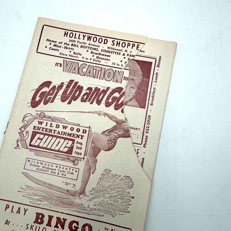 May include: A vintage Wildwood Entertainment Guide from 1969, featuring a surfer illustration and the text "Get Up and Go." The guide promotes the Wildwood Regatta and lists the Hollywood Shoppe with store hours.