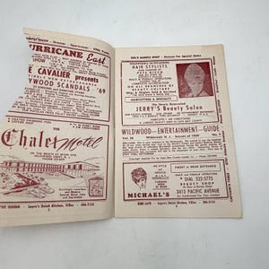 May include: Open magazine pages featuring advertisements for businesses in Wildwood, New Jersey, from 1969. The left page has a motel ad, while the right page showcases beauty salons and entertainment guides. The pages are yellowed.