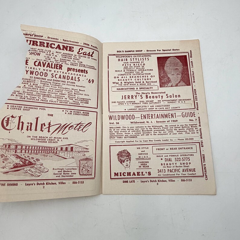 May include: Open magazine pages featuring advertisements for businesses in Wildwood, New Jersey, from 1969. The left page has a motel ad, while the right page showcases beauty salons and entertainment guides. The pages are yellowed.