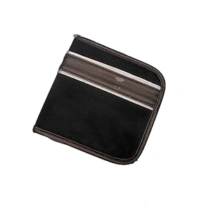 May include: Black, rectangular wallet with a textured surface. The wallet has a brown leather band with two silver stripes across the top. The edges are also brown.