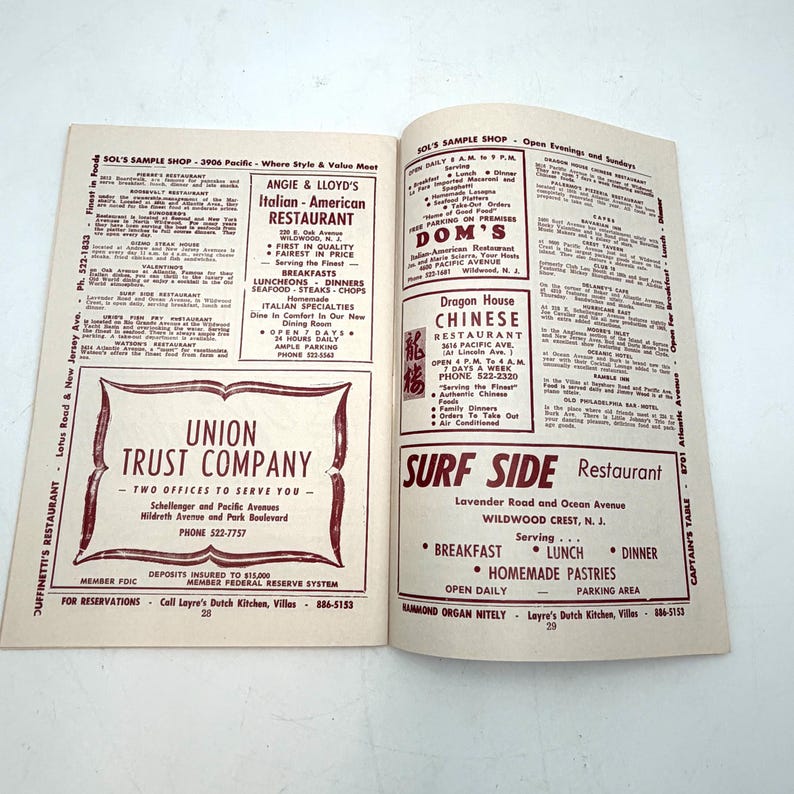 May include: Open booklet with restaurant advertisements, including Angie & Lloyd's Italian-American Restaurant and Dragon House Chinese Restaurant. The booklet also features a Union Trust Company ad. The pages are white with red text.