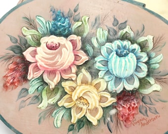 May include: Oval wooden box with a painted floral design. The flowers are pink, yellow, blue, and green. The box is signed "Virginia Anderson".