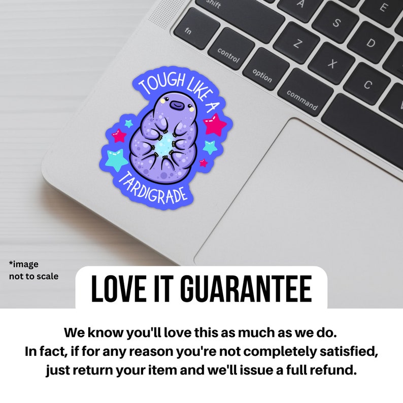 May include: A sticker with a cartoon illustration of a tardigrade, a microscopic animal known for its resilience. The sticker is on a laptop keyboard and features the text "Tough Like A Tardigrade".