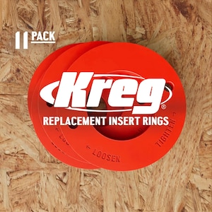 May include: A stack of red Kreg replacement insert rings. The rings have white text that reads "Kreg" and "Replacement Insert Rings". The package is labeled "11 Pack". The background is a wood grain.