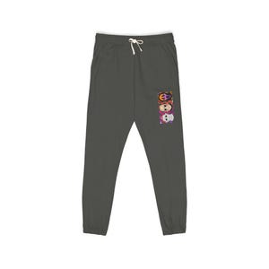 May include: Dark gray sweatpants with a drawstring waist. The pants feature a colorful graphic of three stylized skulls stacked vertically on the right leg. The skulls have intricate designs in orange, purple, and pink.