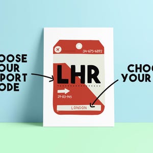 May include: A white print with a red and white graphic of a luggage tag, featuring the airport code "LHR" and the city "London". The text "CHOOSE YOUR AIRPORT CODE" and "CHOOSE YOUR CITY" are also displayed.