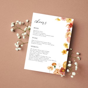 May include: A white card with a floral design on the right side. The card lists a variety of beer, wine, and spirits. The text at the top of the card reads "cheers".