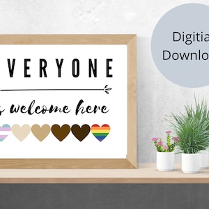 May include: A framed print with the text "EVERYONE is welcome here" in black. Below the text are six hearts in various colors, including a rainbow and transgender flag. The words "Digital Download" are in a light blue circle.
