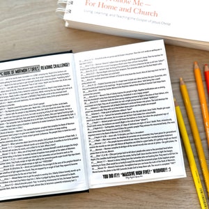 May include: A close-up of an open book with a reading challenge for the Book of Mormon. The book is open to a page with the text "The Epic Book of Mormon Stories Reading Challenge!" and "You Did It!! "Massive High Five! Woohoo!!".