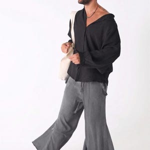 Front view of a man wearing an oversized midnight black linen shirt with a relaxed collar.