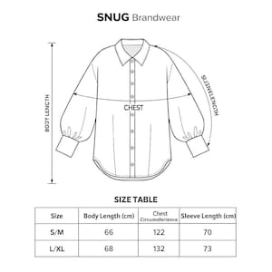 Unisex oversized linen batwing shirt line drawing with button-down front, puff sleeves, curved hem, and size chart.