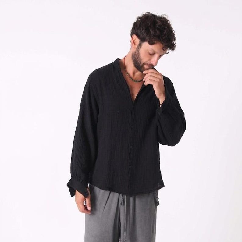 Black linen shirt worn as a lightweight layer for a desert or festival aesthetic.