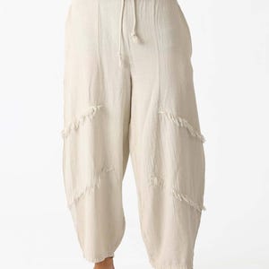 Handmade linen palazzo pants in cream with a drawstring waist and diagonal frayed panels for boho, breathable yoga/meditation style.