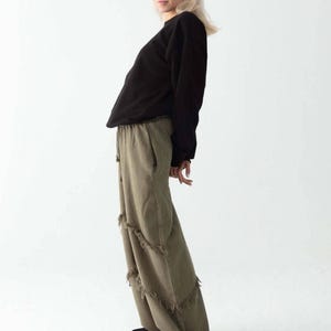 Handmade linen palazzo pants in brown linen pants with fringe, Boho harem style; model wearing black top; Snug Brandwear.