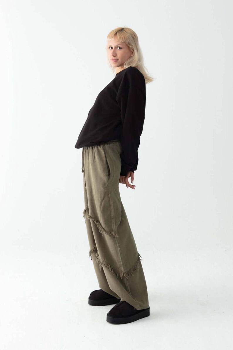 Handmade linen palazzo pants in brown linen pants with fringe, Boho harem style; model wearing black top; Snug Brandwear.
