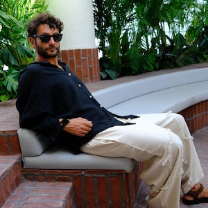 Sustainable black handmade longsleeve shirt used as a versatile daily essential.