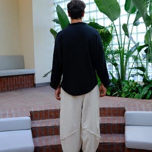 Simple, clean back silhouette of the oversized black linen tunic.
