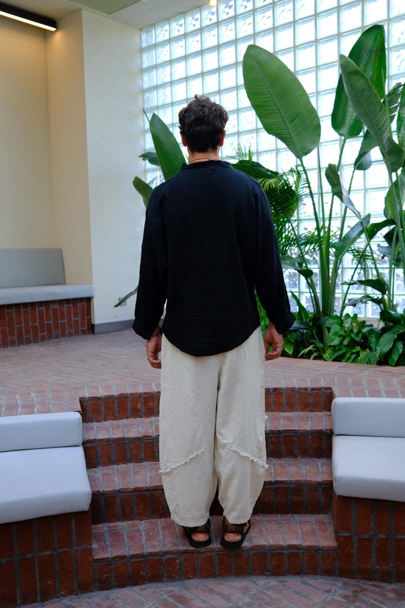 Simple, clean back silhouette of the oversized black linen tunic.