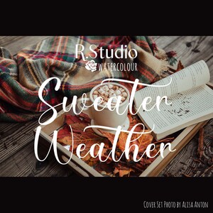 May include: A cozy autumn scene with a mug of hot chocolate topped with marshmallows, a book, and a plaid blanket. The text "Sweater Weather" is written in white cursive font. The image is captioned "Cover Set Photo by Alisa Anton".