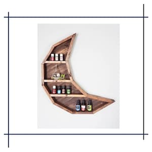 May include: A wooden crescent moon shelf with multiple shelves, holding small bottles of essential oils. The shelf is mounted on a white wall.