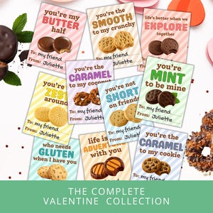 May include: A collection of Valentine's Day cards with cookie-themed puns. Each card features a different cookie type and a playful message like "You're my butter half." The cards are arranged with cookies and decorative hearts.