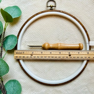 Ruler showing size of display hoop about 8", punch needle tool about 6 inches.