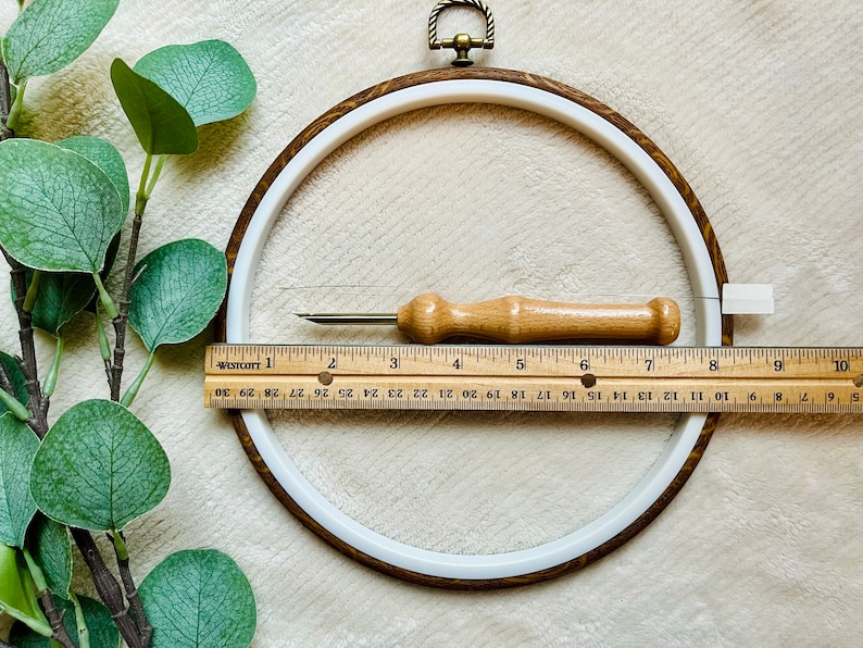 Ruler showing size of display hoop about 8", punch needle tool about 6 inches.