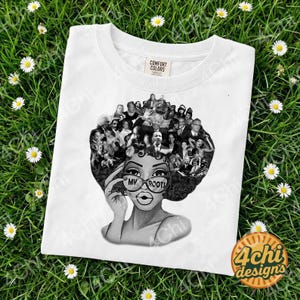 May include: White crew neck t-shirt featuring a black and white graphic of a woman with glasses that read "MY ROOTS." Her hair is a collage of historical figures. The shirt has a "Comfort Colors" tag.