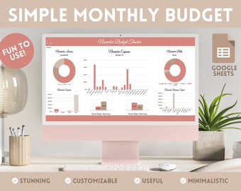 May include: A computer screen displaying a Google Sheets spreadsheet with a simple monthly budget tracker. The spreadsheet has charts and graphs with pink and beige colors. The text on the screen reads "November Budget Tracker". The text "Fun to Use!" is in a pink circle at the top left of the image. The text "Google Sheets" is in a beige rectangle at the top right of the image.