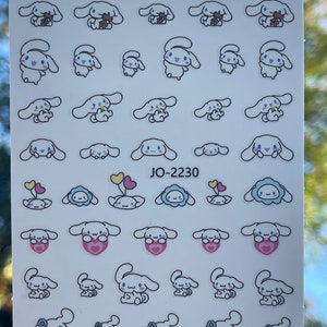 Op de afbeelding: Een vel met witte stickers waarop een cartoonhondje met verschillende gezichtsuitdrukkingen en accessoires te zien is. De hond houdt een teddybeer, een bloem, een hart en een ballon vast. De tekst "JO-2230" staat op het vel gedrukt.