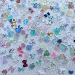 May include: Assortment of colorful resin charms in various shapes and sizes, including animals, stars, hearts, bows, and flowers. The charms are perfect for adding a touch of whimsy to jewelry, crafts, and other projects.