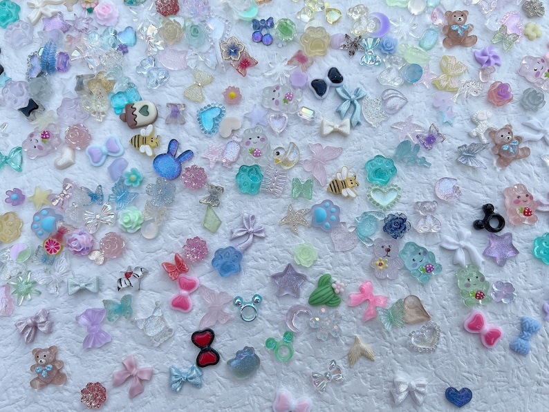 May include: Assortment of colorful resin charms in various shapes and sizes, including animals, stars, hearts, bows, and flowers. The charms are perfect for adding a touch of whimsy to jewelry, crafts, and other projects.