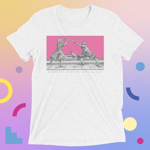 May include: A white t-shirt featuring a pink rectangle with a black and white illustration of two people fencing with swords. The text "HISTORICAL EUROPEAN MARTIAL ARTS" is printed below the rectangle.