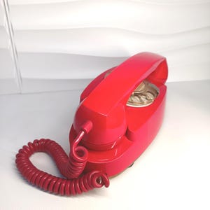 Red vintage handset telephone from the 1970s. Made in Italy.