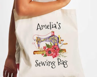 May include: A white canvas tote bag with a vintage sewing machine and red poppies design. The text "Amelia's Sewing Bag" is printed on the bag.