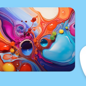 May include: Abstract art mouse pad with colorful swirls and droplets of paint. The colors include blue, green, orange, red, pink, and yellow.