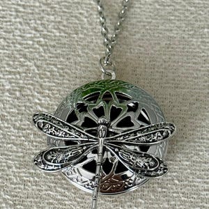 May include: A set of three ceramic mugs with a speckled, matte finish. The mugs are in shades of cream, light brown, and dark brown. Each mug has a simple, minimalist design and a rounded handle.