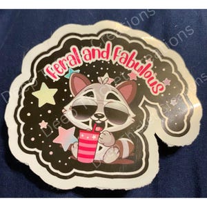 Feral and Fabulous Raccoon in Shades Holding Tumbler Sticker