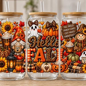 May include: Three clear glass tumblers with bamboo lids and glass straws, featuring colorful autumn-themed graphics including sunflowers, pumpkins, gnomes, ghosts, and text reading "Hello Fall," "Pumpkin Spice Everything," and "Fall Breeze."