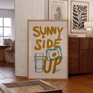 breakfast wall art, funny kitchen poster, egg toast illustration, coffee print, sunny side up wall art, retro breakfast poster, quirky food wall decor, positive quote poster, kitchen art, morning print, food quote poster, vintage print, aesthetic wall art, cafe decor print, modern kitchen wall art, cozy home print, foodie gift idea, uplifting breakfast art, modern kitchen print, inspirational quote, morning routine poster, minimalist kitchen decor, funky wall art, bold food illustration