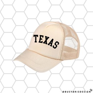 May include: A beige trucker hat with a black mesh back and the word "TEXAS" in black block letters on the front.