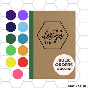 May include: A notebook with a brown cover, green spine, and a black hexagon design that says "YOUR design HERE." A white circle sticker reads "BULK ORDERS WELCOME!" with a colorful palette of circles on the left.
